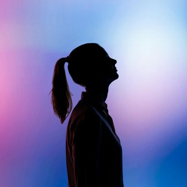 Silhouette of a person in a dynamic pose against a contrasting background.